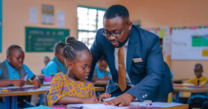 A teacher helping a little girl